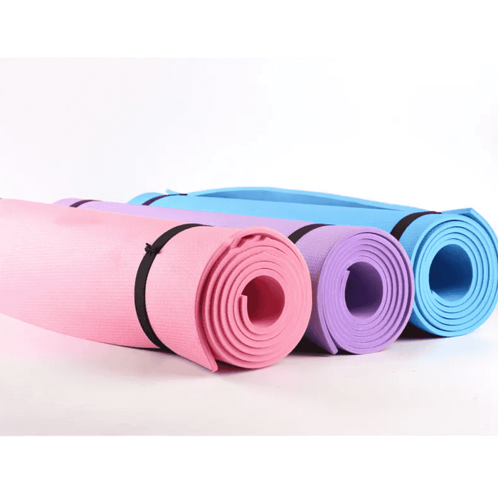 Set of pastel pink, purple, and blue yoga mats rolled up with black straps, designed for versatile workout routines and joint cushioning.