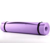 Pink, purple, and blue exercise mats rolled up with black straps, made of shock-absorbing, high-density material for comfortable workouts.