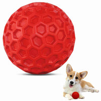 Red honeycomb-patterned dog ball toy made of durable natural rubber with built-in squeaker, perfect for fetch and dental care