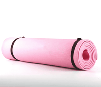 Pink extra thick non-slip fitness mat rolled up with black straps, ideal for yoga, HIIT, and dance workouts, providing superior cushioning and grip.